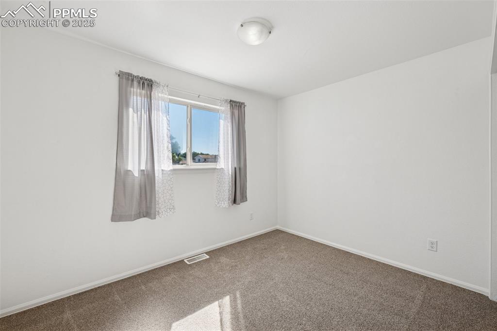 Image 14 of 35: Carpeted spare room featuring baseboards