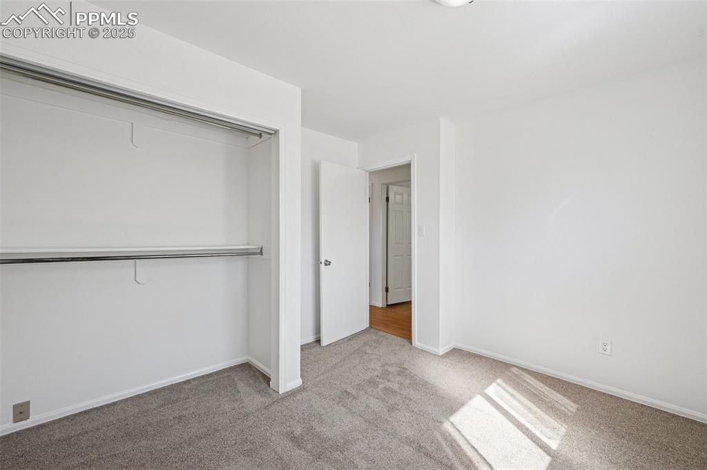 Image 15 of 35: Unfurnished bedroom featuring light carpet and a closet