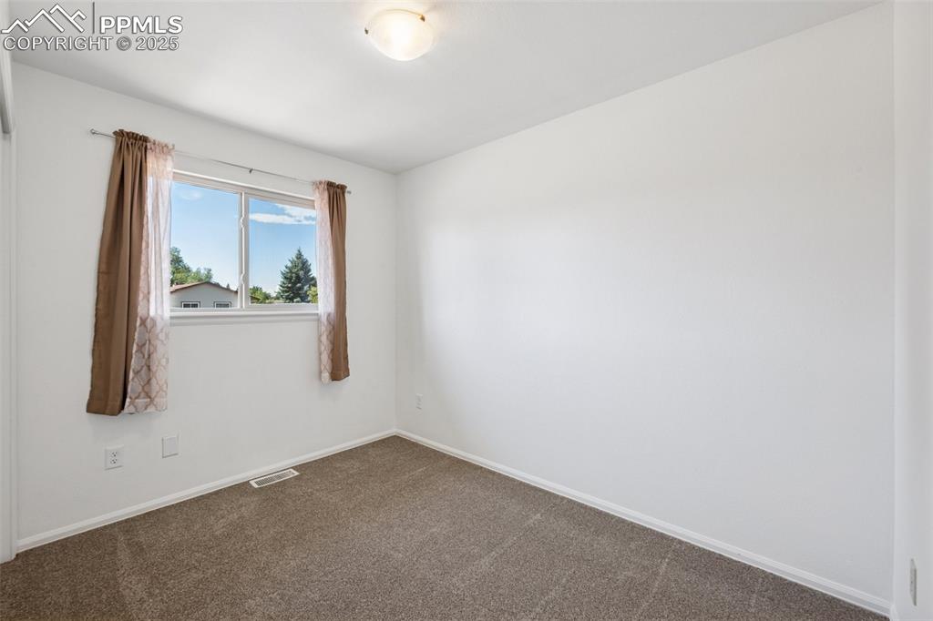 Image 16 of 35: Carpeted spare room with baseboards