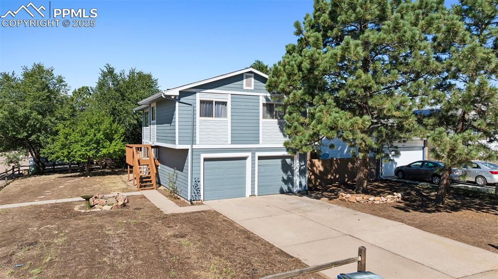 Image 28 of 35: View of front of property featuring concrete driveway and a garage
