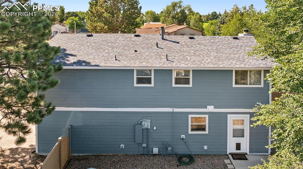 Image 31 of 35: Rear view of house with roof with shingles