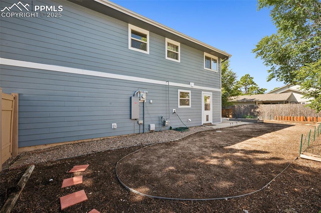 Image 32 of 35: Back of house with a patio area