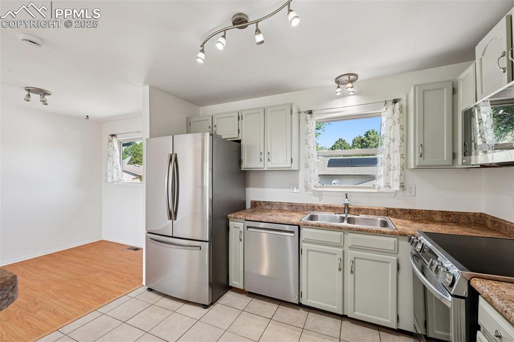Image 4 of 35: Kitchen featuring appliances with stainless steel finishes, plenty of natur
