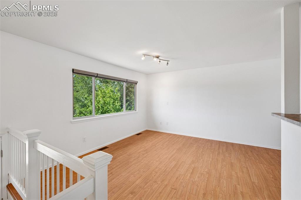 Image 6 of 35: Empty room featuring light wood-style floors and baseboards
