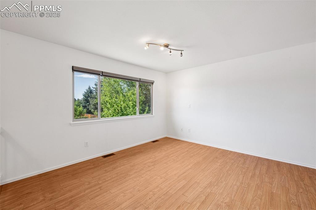 Image 7 of 35: Empty room with light wood-style floors and baseboards