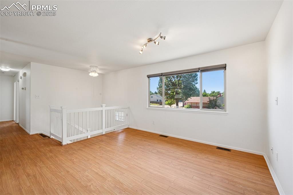 Image 9 of 35: Spare room featuring baseboards and light wood-style flooring