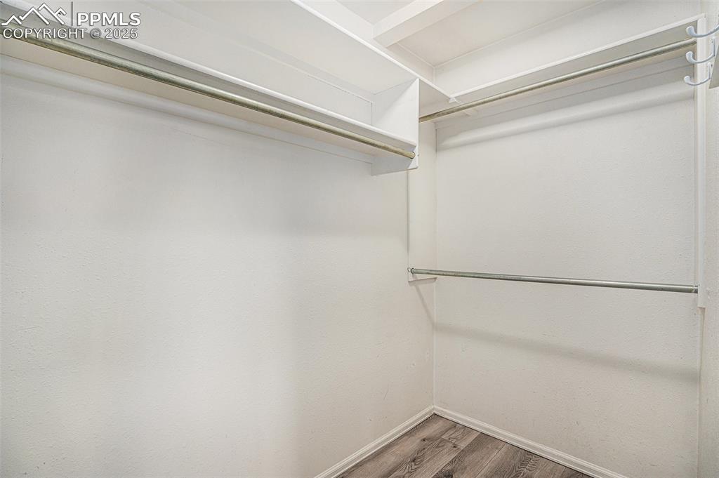Image 14 of 31: Walk in closet featuring wood finished floors