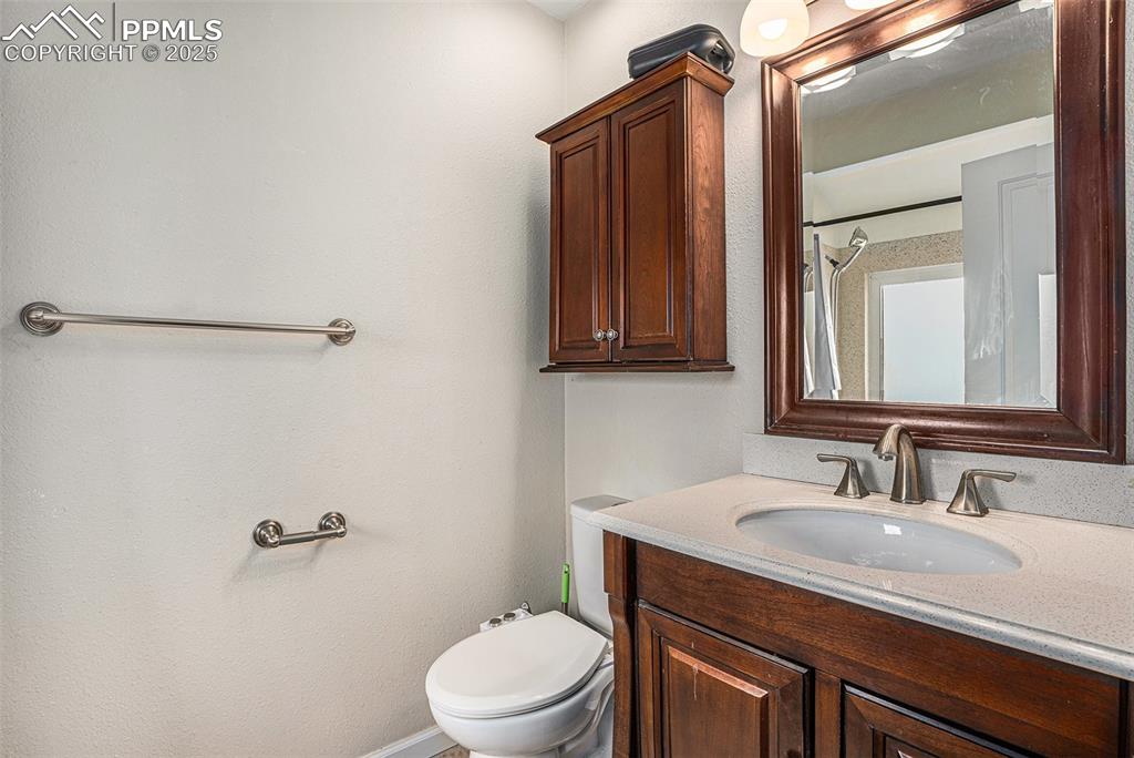 Image 15 of 31: Bathroom featuring vanity and a textured wall