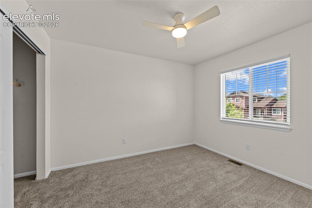 Image 21 of 33: Neutral-toned wall paint and plush carpet flooring