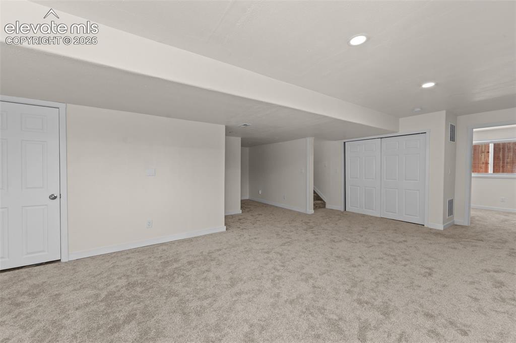 Image 25 of 33: Spacious lower-level room featuring light gray carpeting, recessed ceiling 