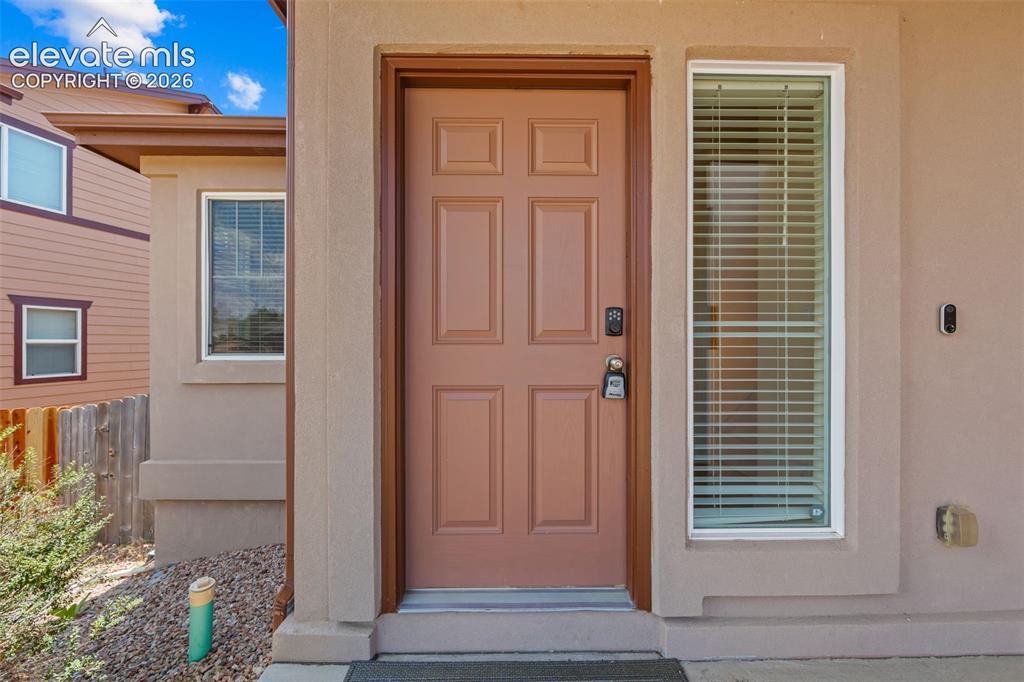 Image 3 of 33: Panel door with a digital lock and a full-length sidelight featuring horizo
