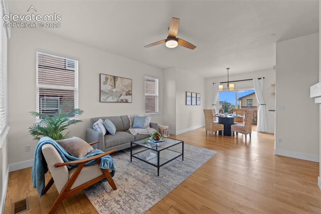 Image 4 of 33: Open-concept living and dining area featuring wood-finish flooring, recesse