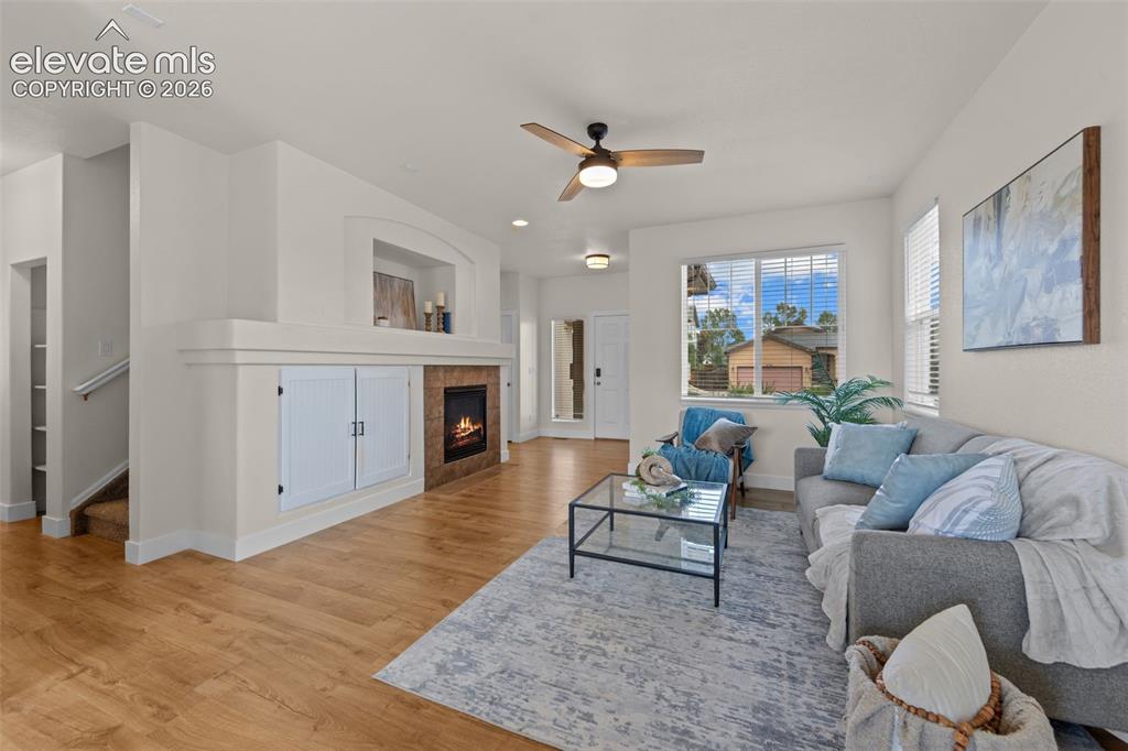 Image 5 of 33: Living area featuring wood-finish flooring and a ceiling fan