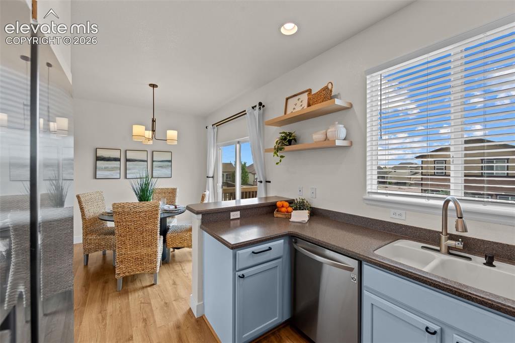 Image 8 of 33: Kitchen featuring light blue cabinetry, stainless steel dishwasher, and a d