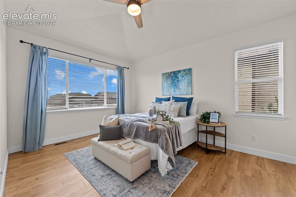Image 9 of 33: Room featuring wood-finish flooring, vaulted ceiling with a flush-mounted c