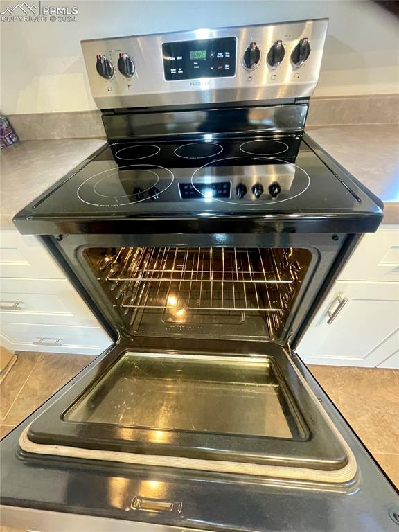 Image 14 of 47: Stainless steel electric range has 5 burners.