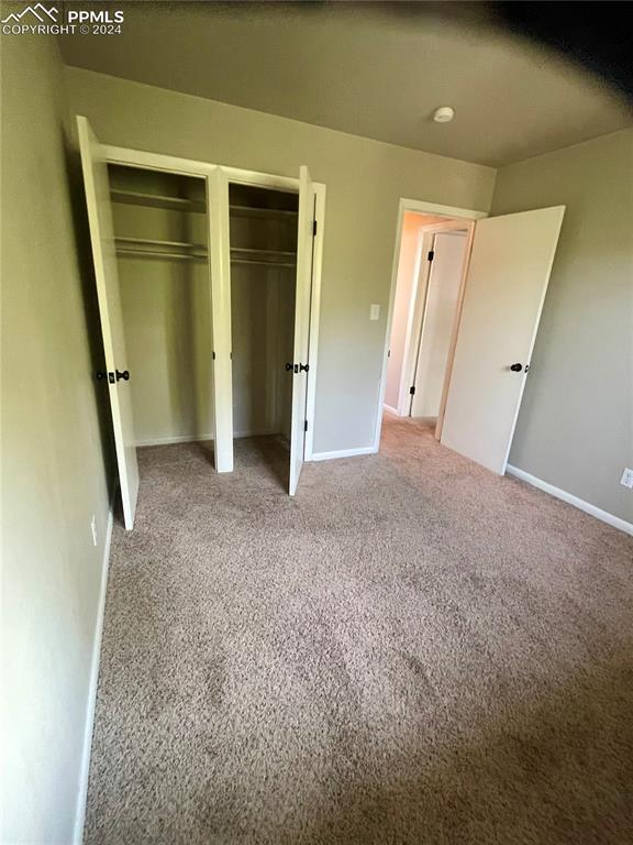 Image 21 of 47: Main level bedroom featuring two closets and carpet flooring