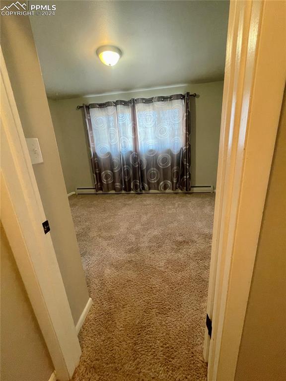 Image 22 of 47: Master Bedroom is carpeted and has a half bath.