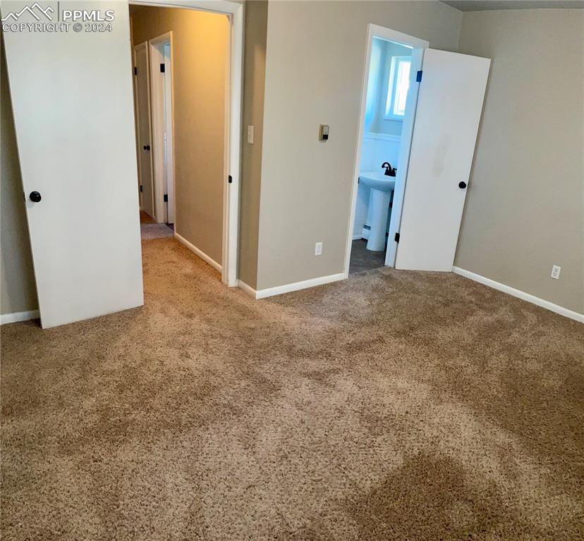 Image 23 of 47: Master Bedroom with half Bath