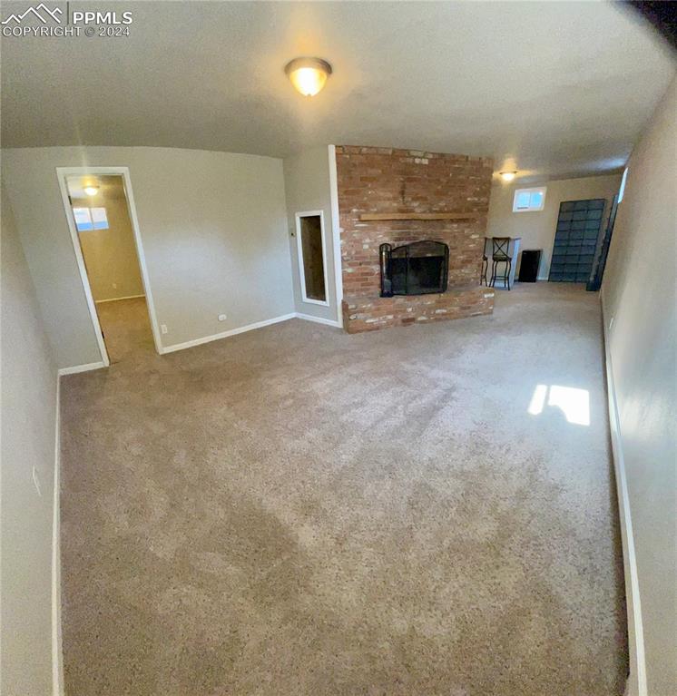 Image 32 of 47: Family room featuring a brick fireplace