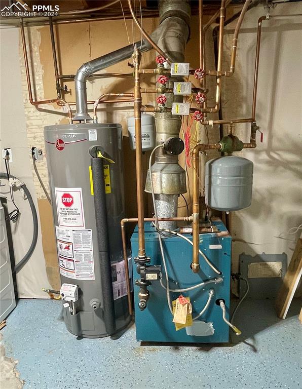 Image 39 of 47: Utility room: gas water heater and hot water heat system.
