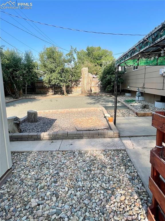 Image 41 of 47: View of back yard with a patio area