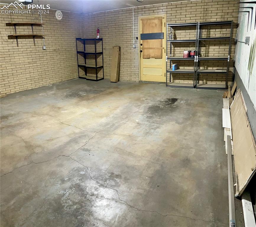 Image 44 of 47: Another View of garage. All shelving stay.