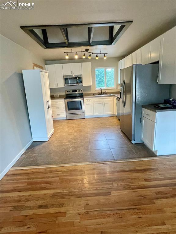 Image 6 of 47: Kitchen has white cabinets; appliances have stainless steel finishes. Lots