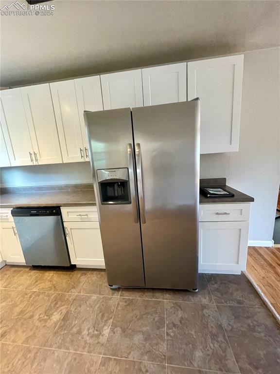 Image 9 of 47: Kitchen featuring white cabinets, stainless steel appliances, white cabinet
