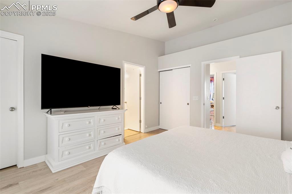 Image 15 of 25: Bedroom featuring light wood-style flooring and ceiling fan