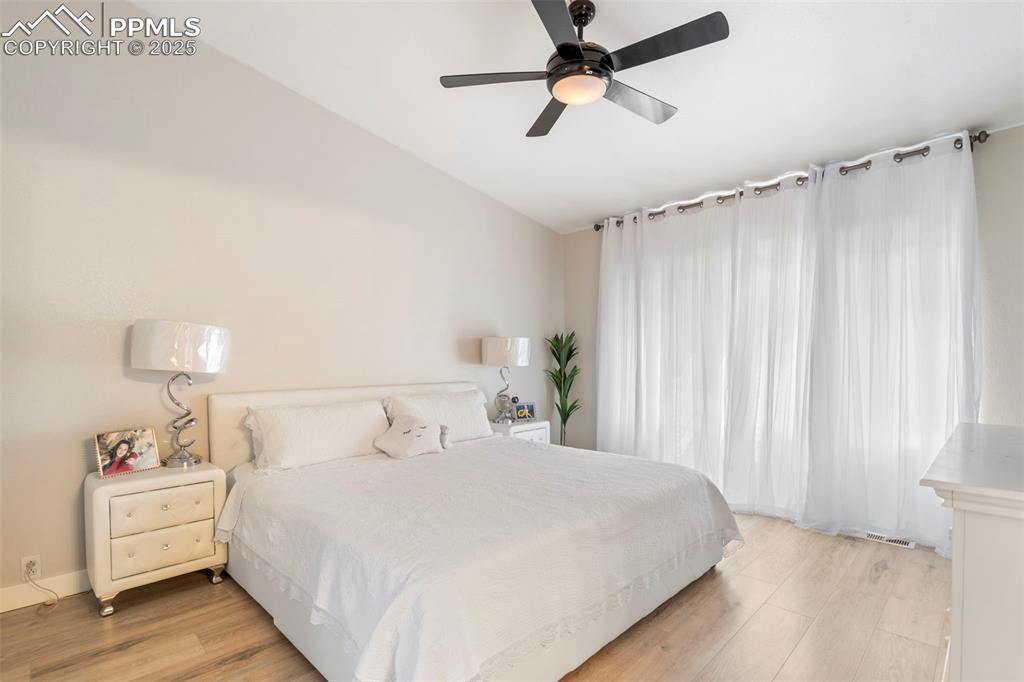 Image 16 of 25: Bedroom featuring light wood-style floors and ceiling fan