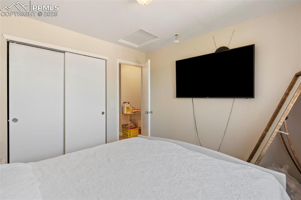 Image 21 of 25: Bedroom featuring attic access and a closet