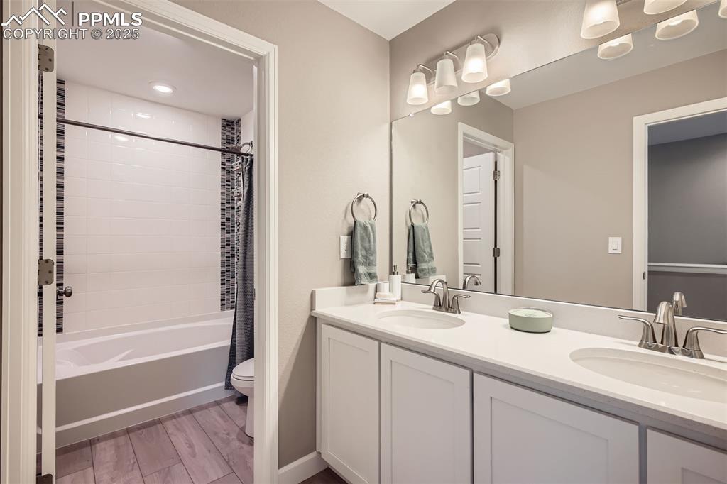 Image 22 of 30: Full bath upstairs with accent tile and upgraded EVP flooring