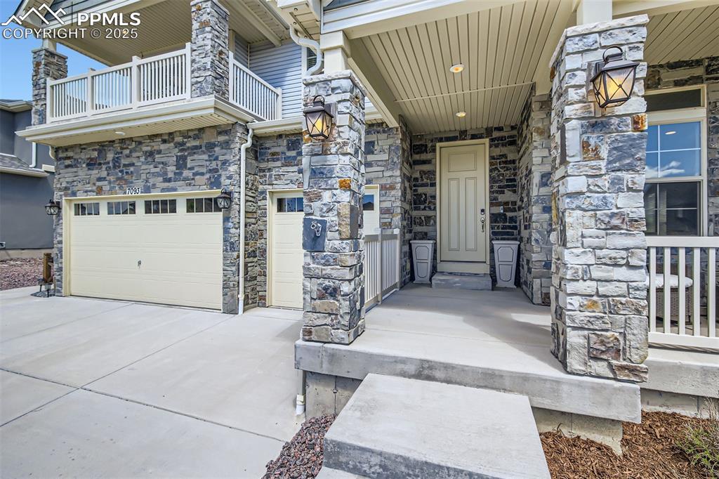 Image 28 of 30: Exterior has gorgeous stone accents, a 3 car garage and large covered porch
