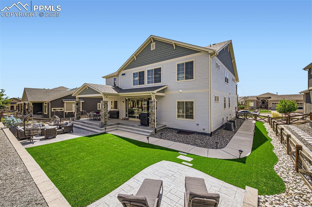 Image 29 of 30: Backyard is a no-maintenance oasis with a covered patio, green space to pla