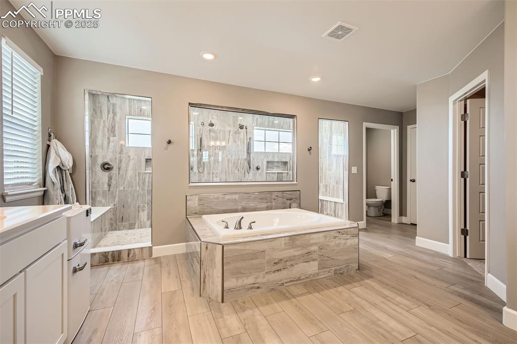 Image 5 of 30: Your dream bathroom!! Multiple showerheads, high-end finishes, and a waterf
