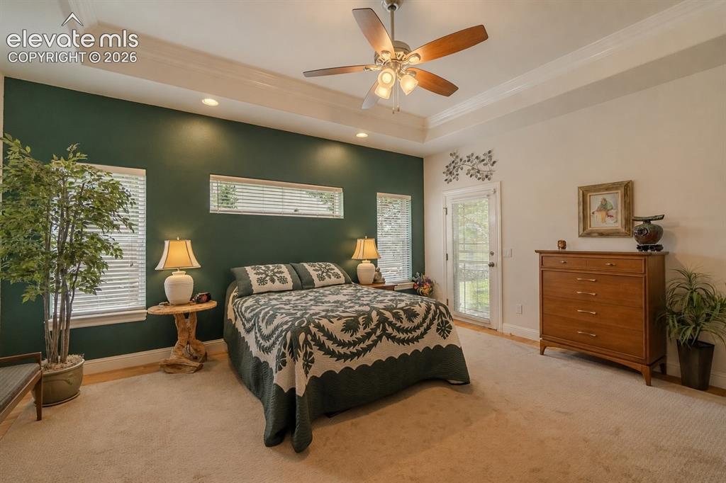 Image 15 of 47: Spacious room featuring a tray ceiling with a ceiling fan, recessed lightin