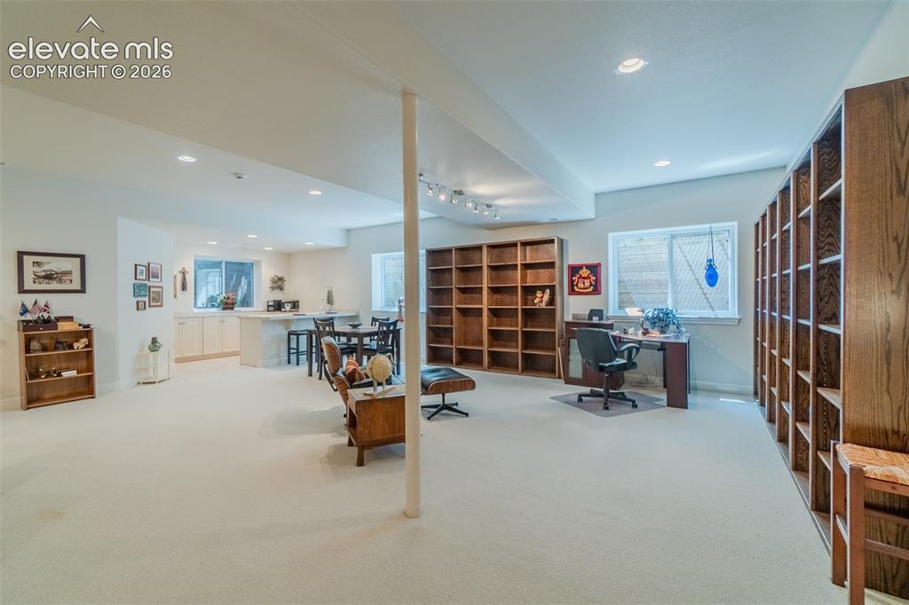 Image 28 of 47: Spacious lower-level area featuring recessed lighting, extensive built-in w