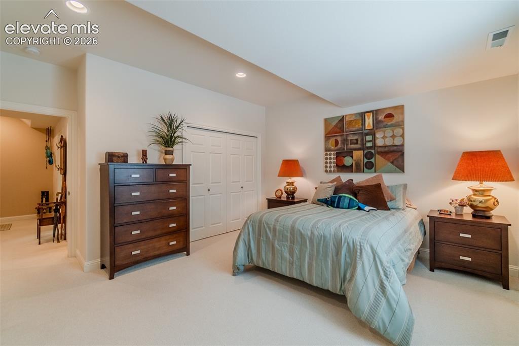 Image 30 of 47: Carpeted room featuring recessed lighting and a doorway leading to another