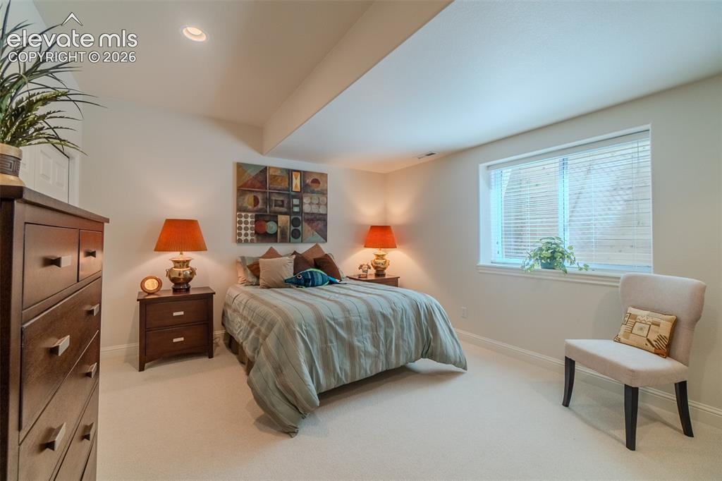 Image 31 of 47: Carpeted bedroom featuring recessed lighting and a window with blinds