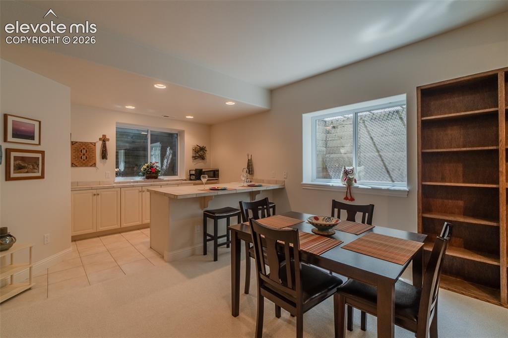Image 34 of 47: Integrated kitchenette with light-toned cabinetry and countertops, featurin