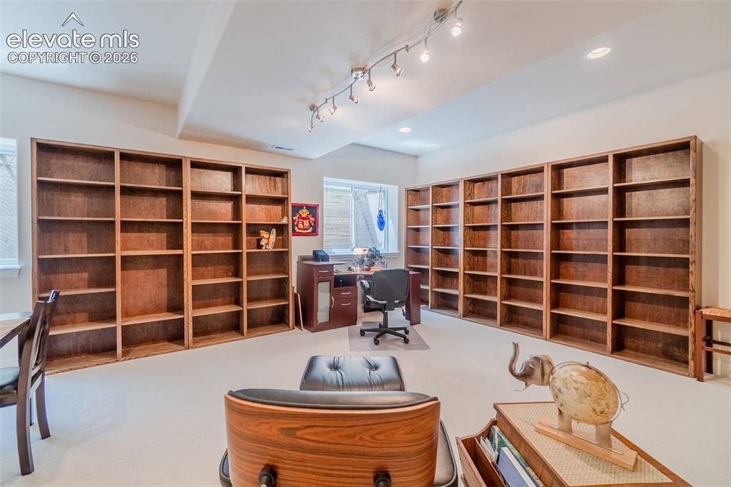 Image 36 of 47: Extensive built-in wood shelving across two walls