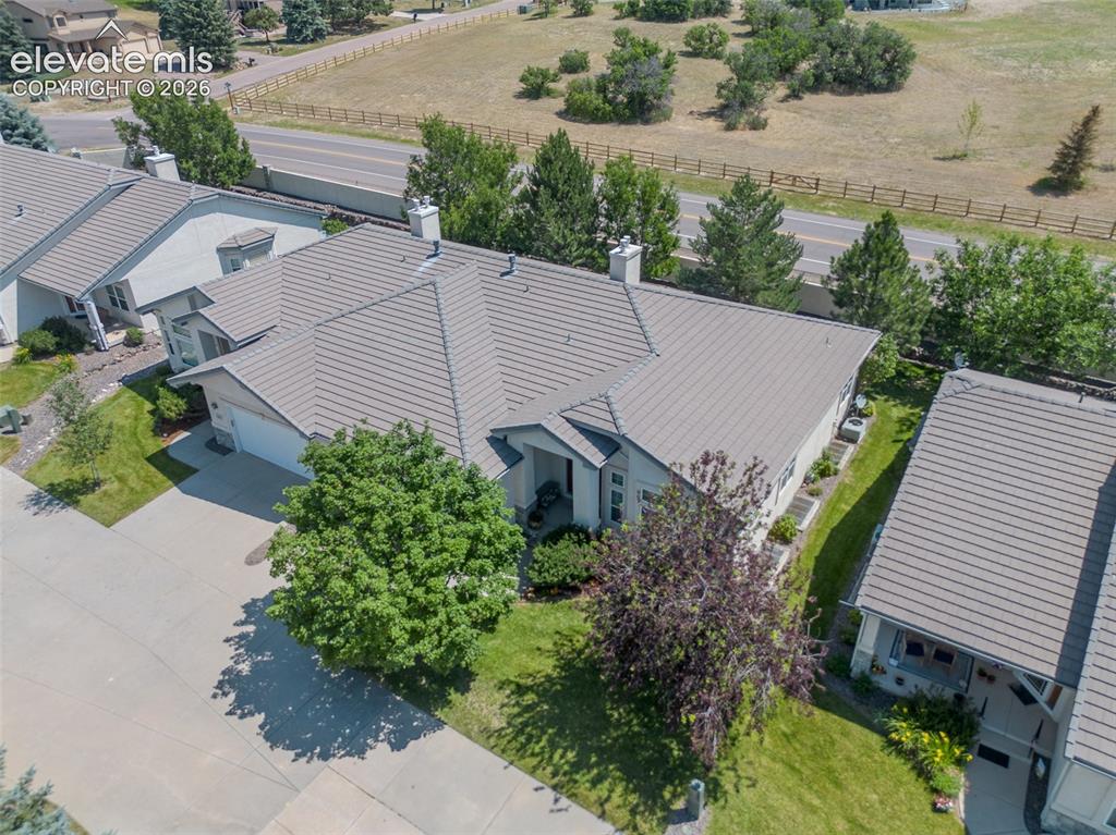 Image 41 of 47: Aerial view of this Single-story residence featuring a tile roof, light-col