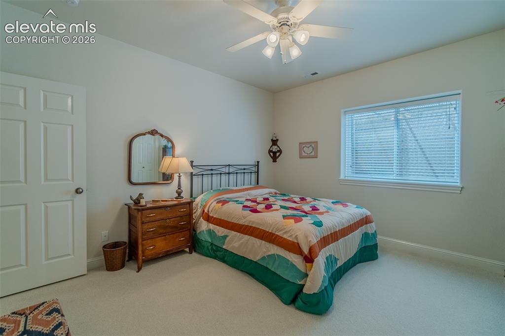 Image 42 of 48: Room featuring neutral wall tones, a six-panel interior door, a ceiling fan