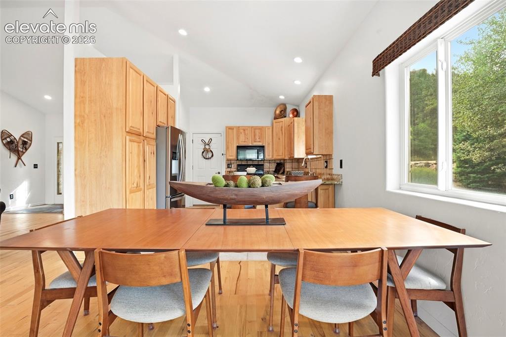 Image 14 of 49: Vaulted ceilings, recessed lighting, wood-finish flooring, wood cabinetry,