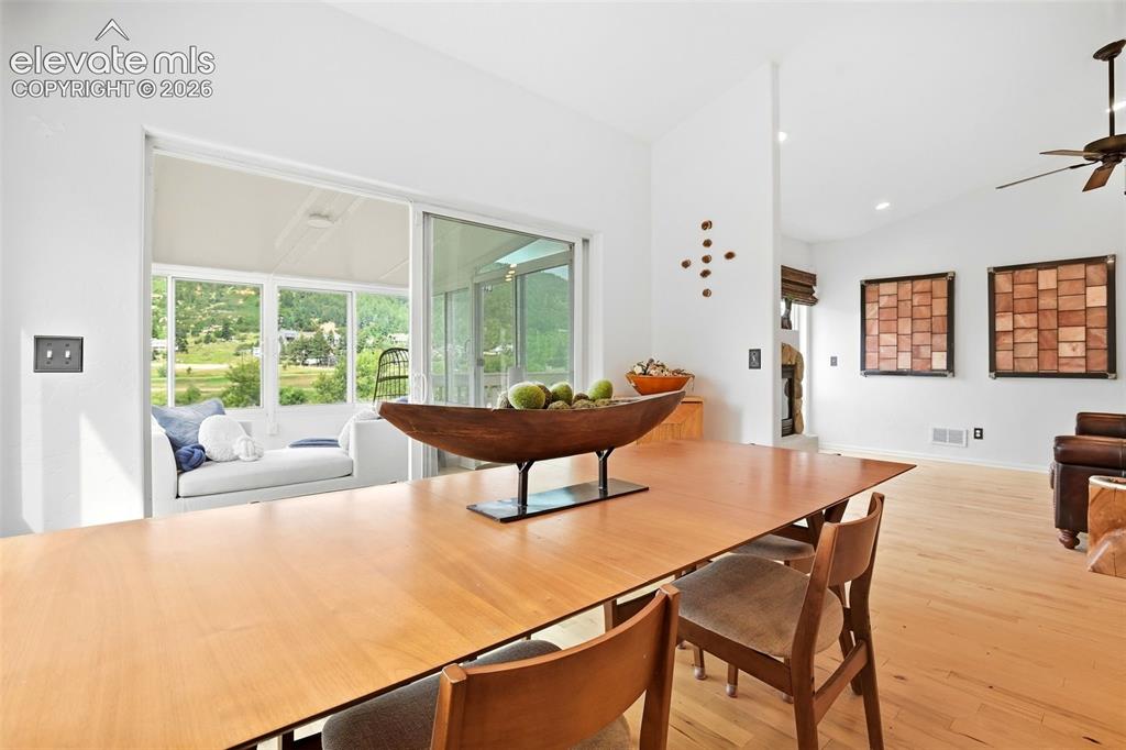 Image 16 of 49: Vaulted ceiling with recessed lighting, wood-finish flooring, white walls, 