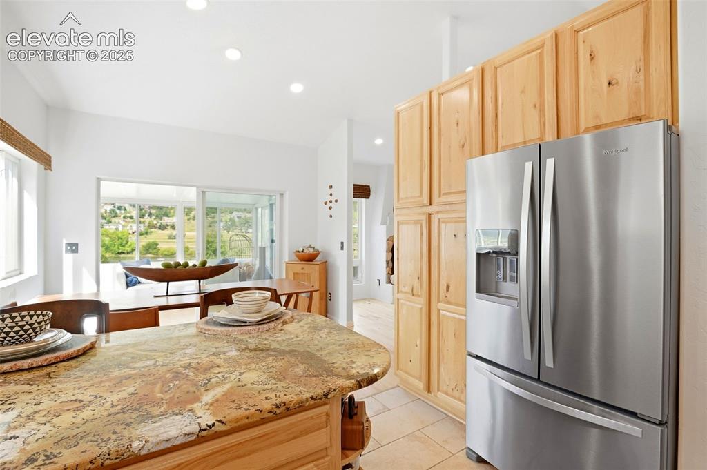 Image 31 of 49: Kitchen featuring natural wood cabinetry, a stainless steel French door ref
