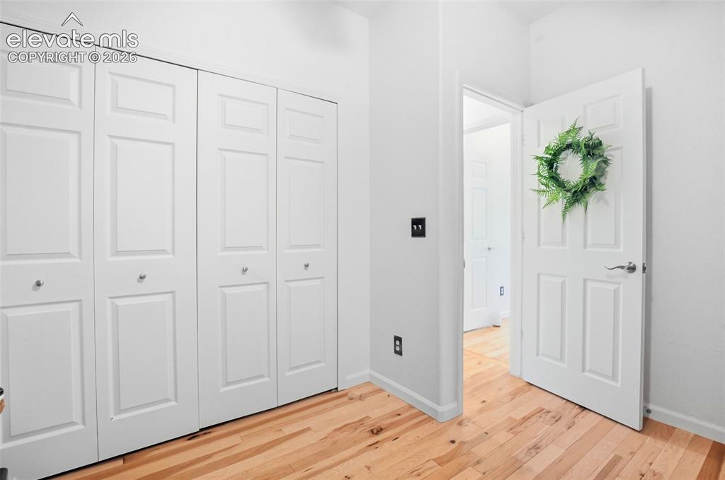 Image 36 of 49: Wood-finish flooring with white trim