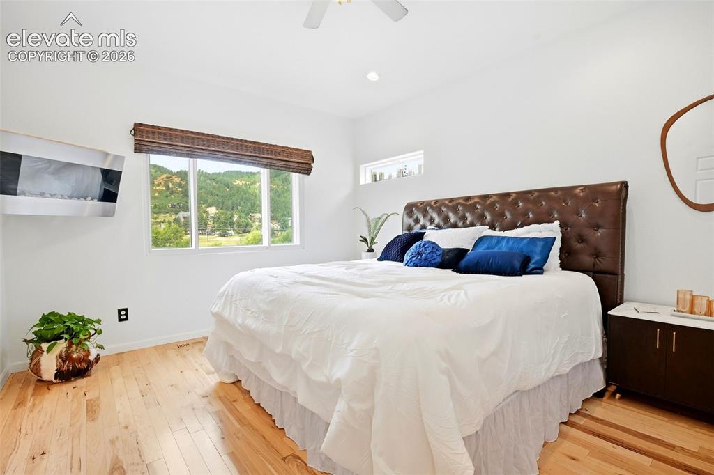 Image 37 of 49: Light wood-finish flooring with a white wall finish