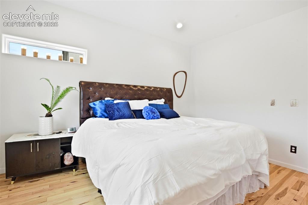 Image 38 of 49: Wood-finish flooring, white walls, and a recessed ceiling light
